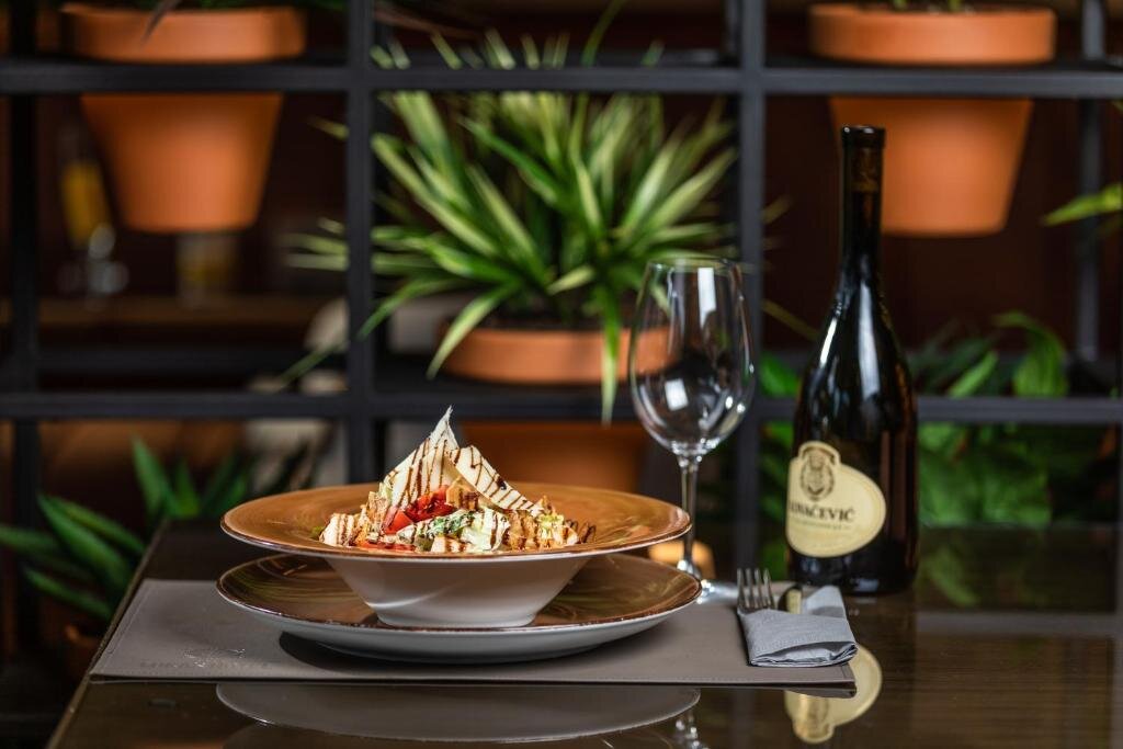 Freshly prepared salad and local wine served at Hotel Luka's restaurant